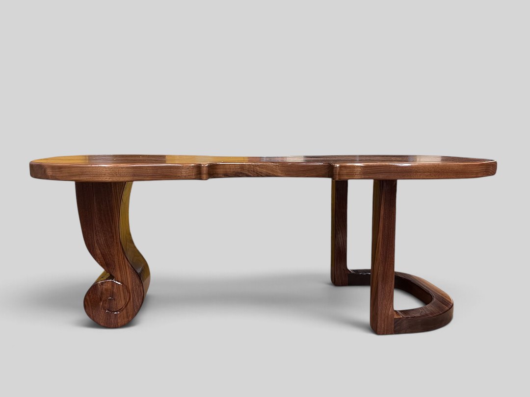 Espressivo from the side: the violin-shaped walnut top, the scroll leg and the looped leg