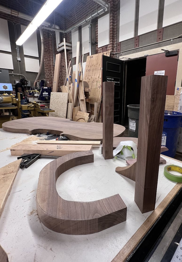 The cut table top and leg pieces in the shop