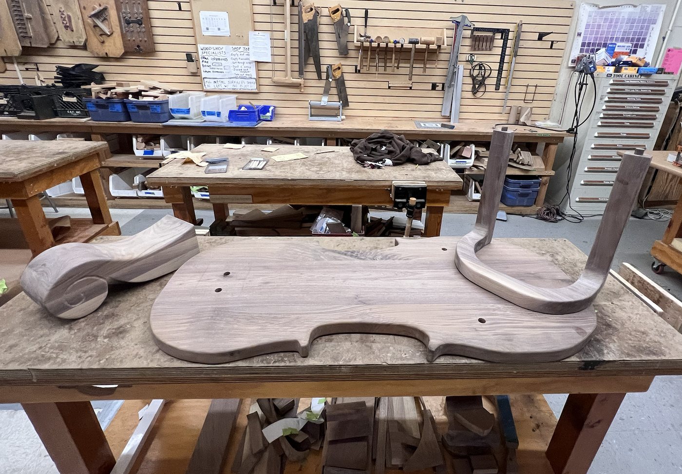 The sanded table top, scroll leg and looped leg before assembly