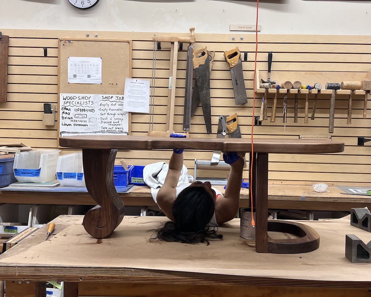 Symphony applying varnish under the assembled table