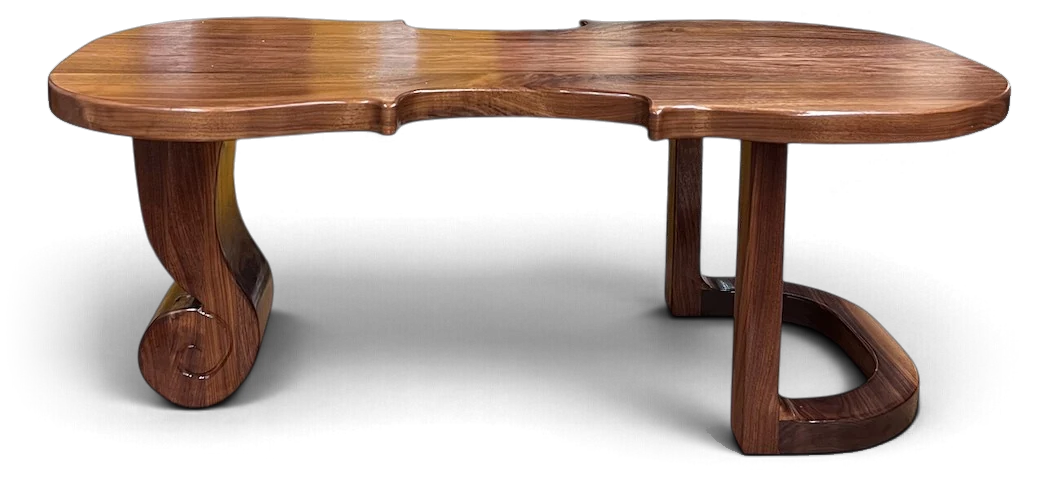 Espressivo: a walnut coffee table with a violin-shaped top, a scroll-shaped leg on one end and a looped leg on the other