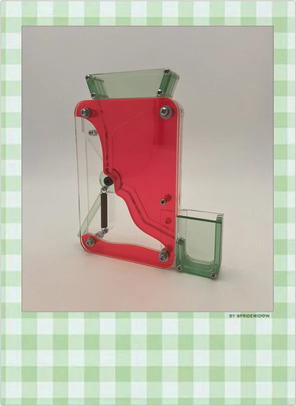 Candy Dispenser: a pink and green translucent acrylic candy dispenser