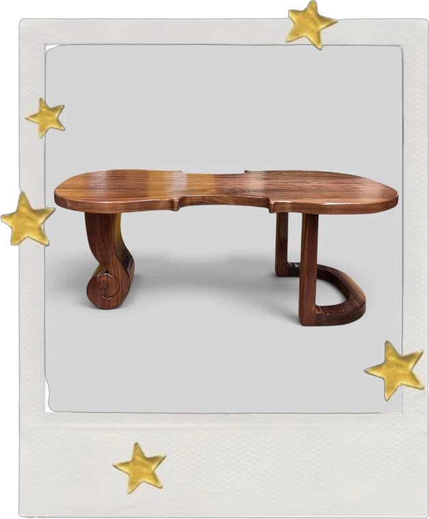 Espressivo: a sculpted wooden table with scrolled legs