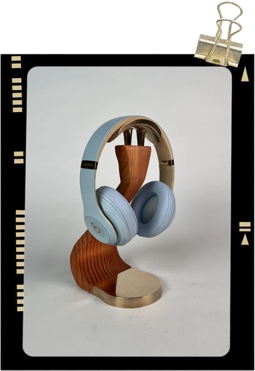 Headset Habitat: headphones resting on a bronze and cherry-wood stand