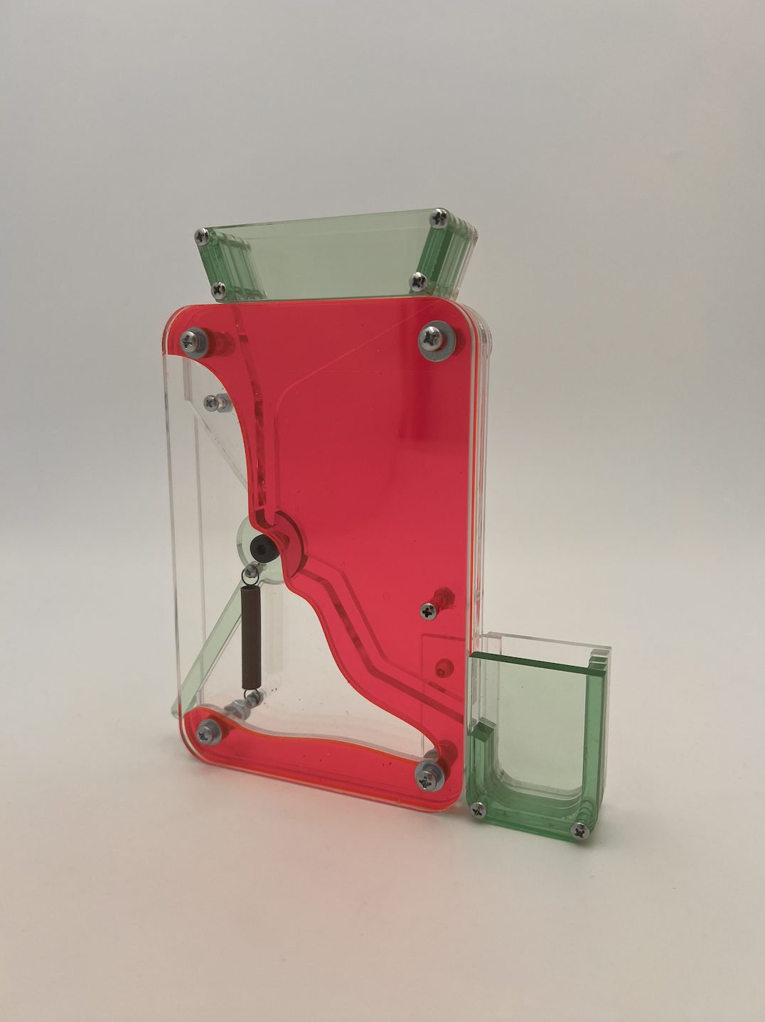 Candy Dispenser: a pink and green translucent acrylic candy dispenser