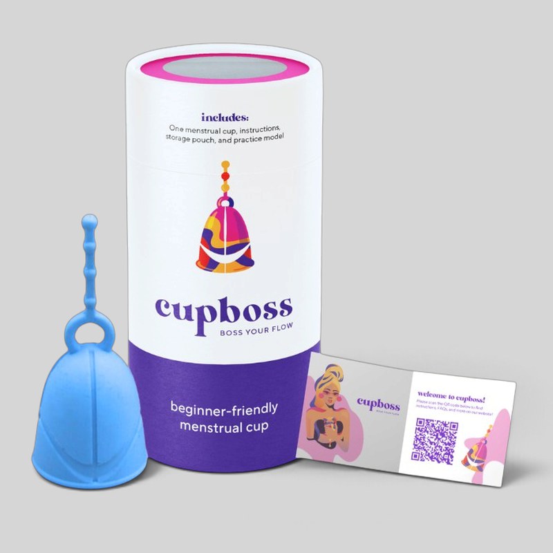 CupBoss: a blue menstrual cup next to its purple and white CupBoss packaging