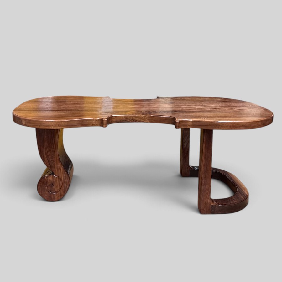 Espressivo: a sculpted wooden table with scrolled legs